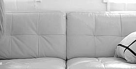 Blonde and Brunette Lesbian Kissing on Couch'