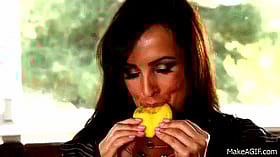 Brunette Babe in Kitchen Licking Lips While Eating Mango'
